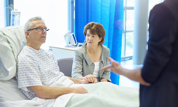 A nurse discusses palliative care with a patient and his partner
