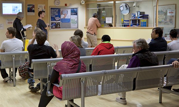 People sitting on rows of benches at the emergency department of the Royal Free Hospital in London