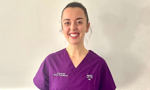 A smiling advanced nurse practitioner in NHS Fife's new purple uniform 