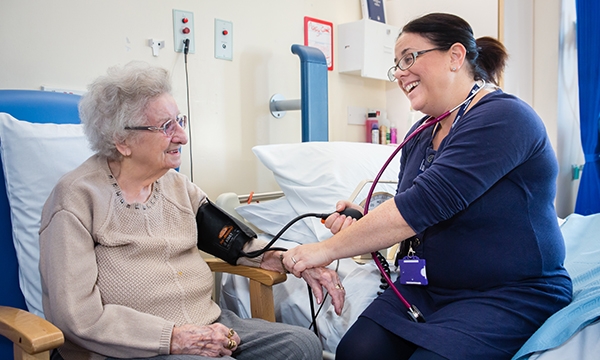 Wendy Mashlan treating an elderly female patient