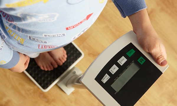 Obese child on scales